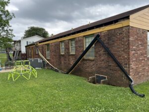 Entire gutter system collapsed from the roof and some parts are on the grass beside the house in Madison, AL