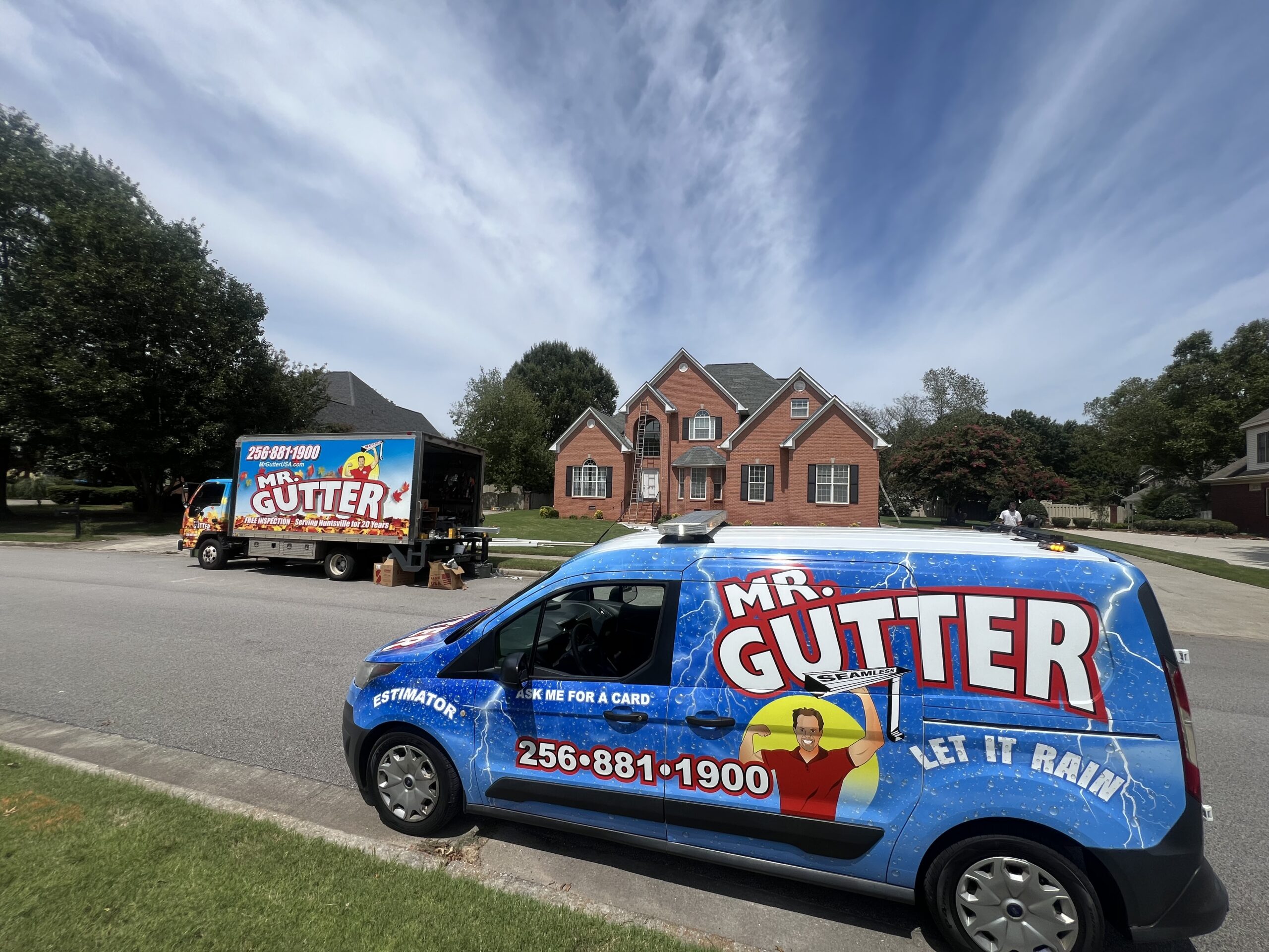 Mr Gutter panel truck and service van parked in front of a client’s home in Madison, AL