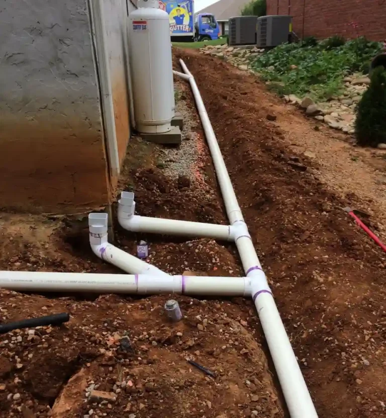Close-up view of underground drain installation showing drainage pipes and soil bedding in Harvest, AL